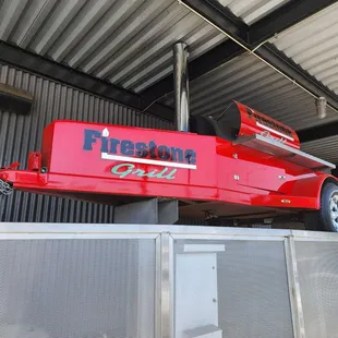 a red firetruck mounted on top of a building