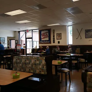 people sitting at tables in a restaurant