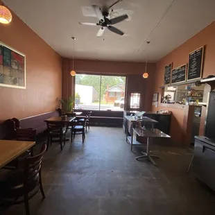 the inside of a restaurant with tables and chairs