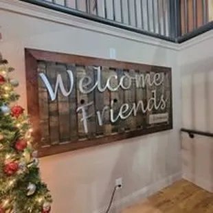 christmas tree and welcome friends sign