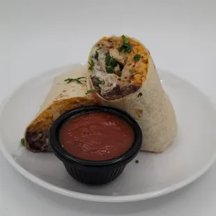 a burrito with salsa