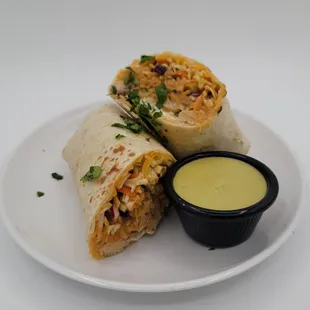 a burrito with a side of sauce