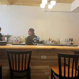 two men sitting at a bar