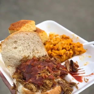 Pulled pork sandwich, mac and cheese, and cornbread.