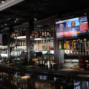 a bar with many bottles of alcohol