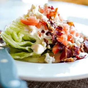 Classic Wedge Salad with your choice of house-made bleu cheese dressing or Chipotle Ranch. Served as a substitution side or an added salad.