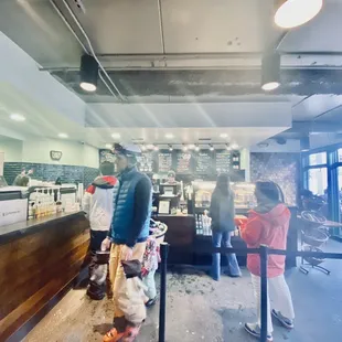 a man standing at a counter in a restaurant