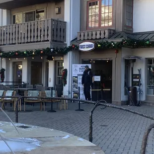 a man standing outside of a restaurant