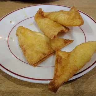 Cream cheese wontons, they actually come in a set of six, but we couldn&apos;t help ourselves.