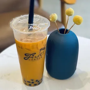 a cup of iced tea and a blue vase