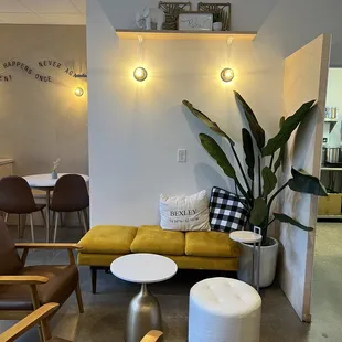 a yellow couch and two chairs