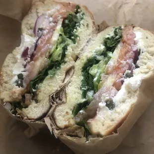 Lox bagel! Includes salmon, cream cheese, capers, lettuce, onions, and tomatoes