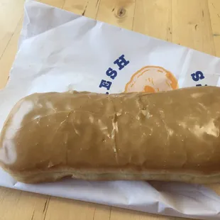 a glazed donut on a paper bag