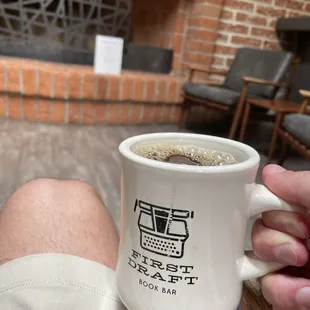 a person holding a coffee mug