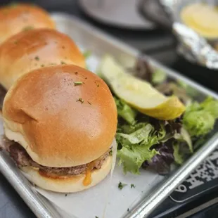 Burger Sliders (3): 3 Angus beef patties, white cheddar cheese,  sautéed onion, house spread sauce
