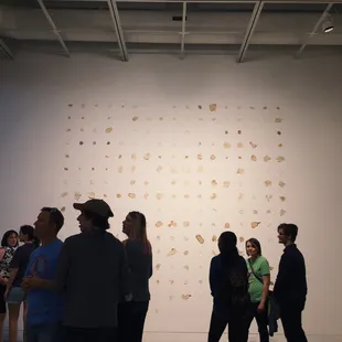 a group of people standing in a gallery