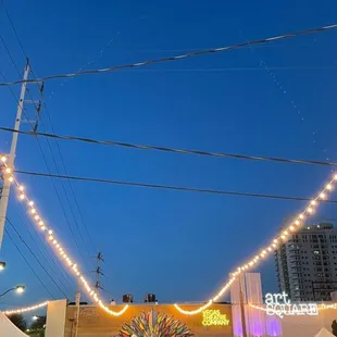 a crowd of people walking around a market