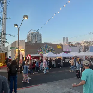 a crowd of people at an outdoor market