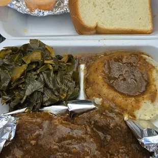 Smothered pork chops (bottom), collard greens, mashed potatoes, crab cake sandwich and brioche