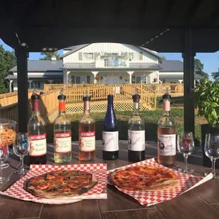 a table with wine and pizza