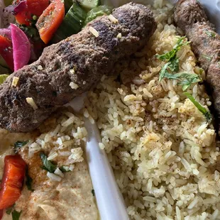 a tray of rice, meat and vegetables