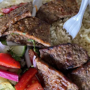 a plate of meat and rice