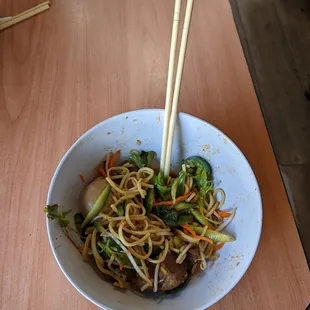 a bowl of noodles and broccoli