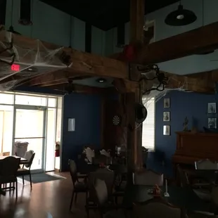 a dining room with blue walls and wood beams
