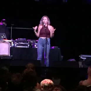 a woman singing on stage