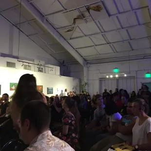 a crowd of people sitting in a room