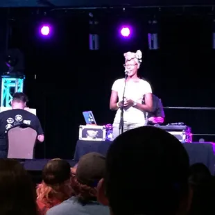 a woman singing on stage