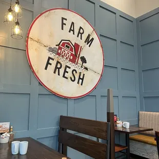 a farm fresh sign on the wall of a restaurant