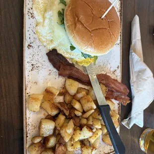 Elevated-Egg sandwich with bacon and potatoes.