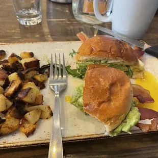 Breakfast sandwich with fried egg, bacon, avocado and Gruyère on brioche bun. Serious yum!