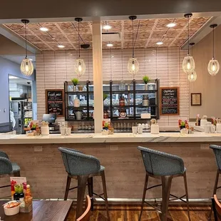 a restaurant with a bar and chairs