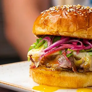 a close up of a burger on a plate