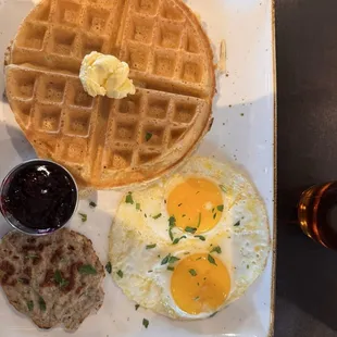 Belgian waffle, chicken (?) sausage, and two sunny side up eggs.
