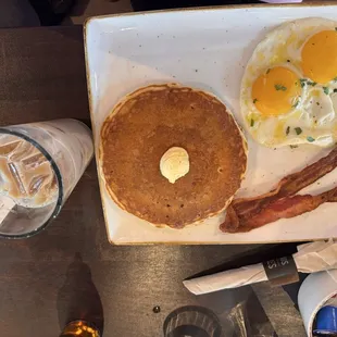 Multi grain pancake, bacon, two sunny side up eggs.
