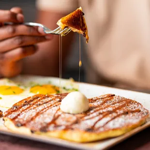 a plate of food with pancakes and eggs