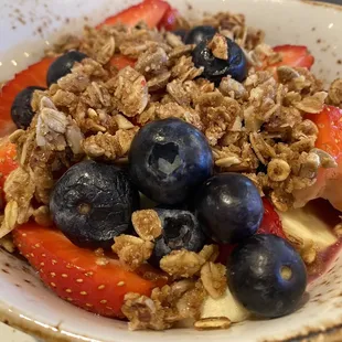 Coconut milk chia seed pudding with fresh bananas and berries, mixed berry compote and housemade granola.