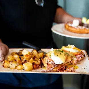 a person holding a plate of food