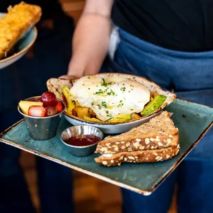 a person holding a plate of food