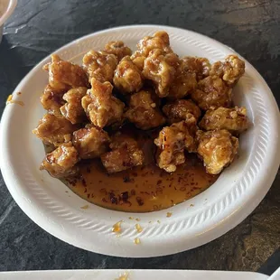 a plate of fried chicken with sauce