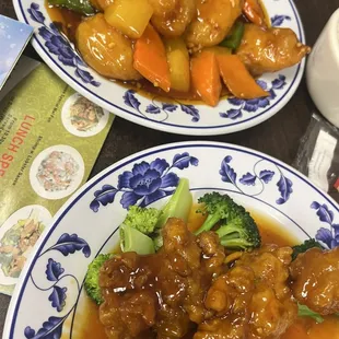 Orange chicken and Pineapple chicken meals with white rice.