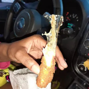 a person holding a piece of food in their hand