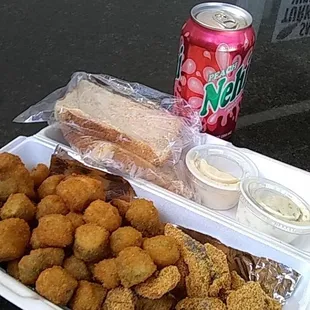 a tray of fried food and a can of soda