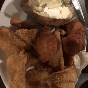 a plate of fried fish and a baked potato