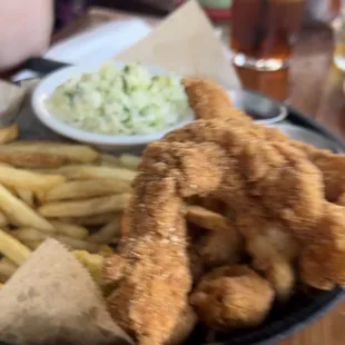 a basket of fried fish and fries