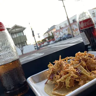 a bottle of coke and a plate of food