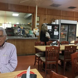 a man sitting at a table in a restaurant